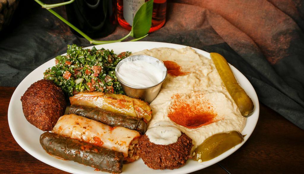 Combo · Served with hummus, baba ghanouj, tabouli, grape leaves, cabbage rolls, kebbe ball, falafel patty and laban.