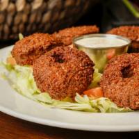 Falafel Platter · Fried vegetarian patties on a bed of lettuce, tomatoes and parsley served with tahini dippin...