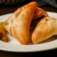 Spinach Pies · Baked bread stuffed with spinach, onions, and seasoned with lemon juice. Serving of 3.