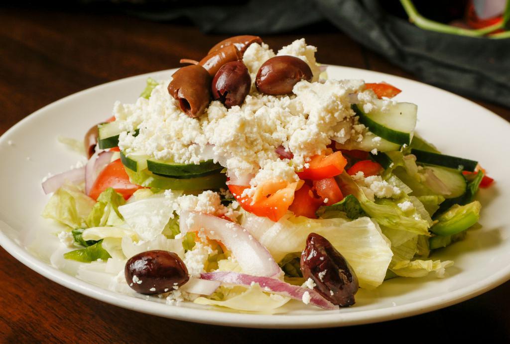 Large Greek · Iceberg and romaine lettuce topped with cucumbers, tomatoes, onions, bell peppers, feta, olives and our signature dressing.  Add grilled chicken, chicken shawarma, beef shawarma, gyro or falafel for an additional charge.
