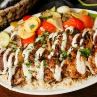 Mixed Grill · Chicken kebab, shish kebab, and kafta over rice with a side of sautéed vegetables and topped...