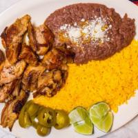 Carnitas · Chunks of pork deep-fried and served with Mexican rice, refried beans, tortillas and guacamo...