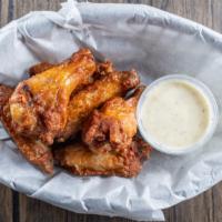 Western Wings  · 6 crispy fried naked wings tossed in  your choice of sauce. Served with side dressing.  Or u...
