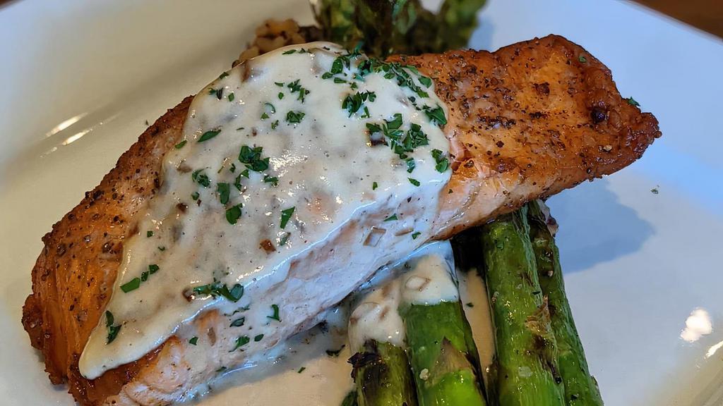 Pan Seared Salmon · 8oz Atlantic Salmon with asparagus and red rice grain blend served with a side of brown butter lemon cream sauce.