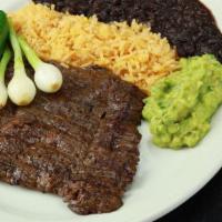 Carne Asada · Charbroiled skirt steak. Served with Mexican rice, refried beans, guacamole, pico de gallo, ...