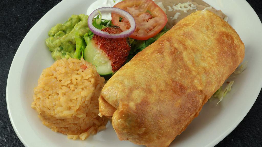 Chimichanga · Deep-fried burrito filled with your choice of meat and topped with guacamole, pico de gallo and shredded cheese. Served with Mexican rice and re fried beans.