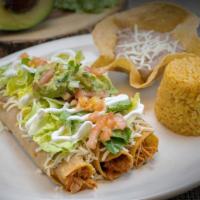 Flautas De Pollo · Three jumbo corn tortillas rolled and filled with chicken, the flautas are topped with sour ...