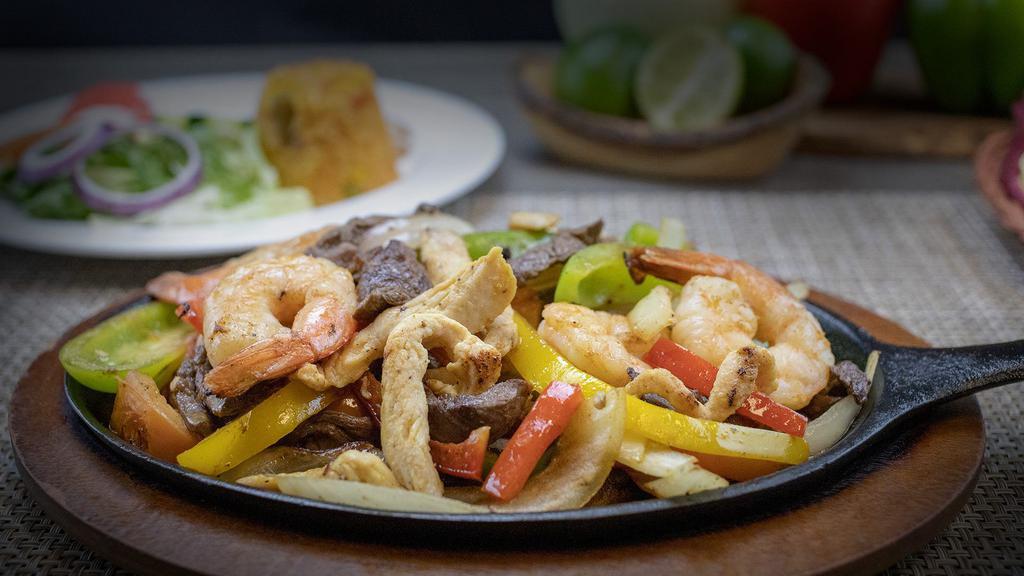 Fajita Mix · Our amazing fajita mix of steak, chicken, and shrimp. A sizzling hot choice accompanied by caramelized Spanish onions, diced tomato, sautéed green and red bell peppers. Served with Mexican rice, refried beans, sour cream, pico de gallo, lettuce and tomatoes.