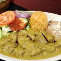 Guisado De Puerco · Tender chunks of pork stewed with spicy green salsa. Served with Mexican Rice, re fried bean...