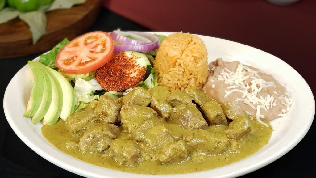 Guisado De Puerco · Tender chunks of pork stewed with spicy green salsa. Served with Mexican Rice, re fried beans, lettuce, tomatoes, and slices of avocado.