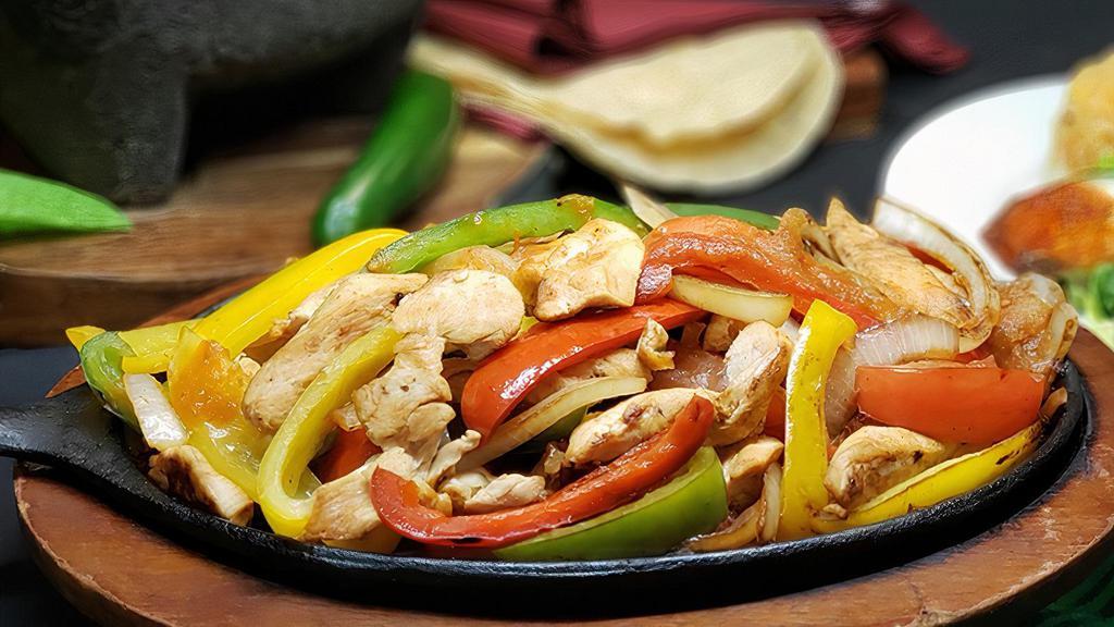 Chicken Fajitas · A sizzling hot choice accompanied by caramelized Spanish onions, diced tomato, sauteed green and red bell peppers. You can choose from chicken or steak. Served with Mexican rice, re fried beans, sour cream, pico de gallo lettuce, and tomatoes.