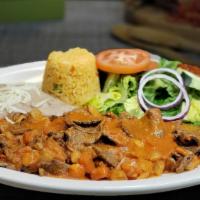 Bistec Ranchero · Succulent pieces of steak stewed with our ranchero sauce. Served with Mexican rice, refried ...