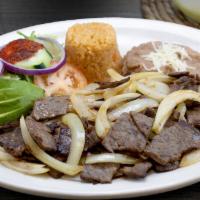 Cecina Encebollada · Succulent pieces of steak sauteed with grilled Spanish onion. Served with Mexican rice, refr...