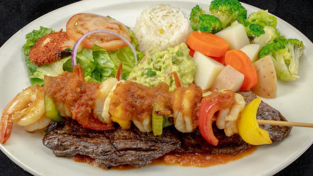 Mar Y Tierra · Charbroiled skirt steak topped with guacamole and grilled shrimp. Served with steamed vegetables,  rice, sour cream, pico de gallo, lettuce, and tomatoes.