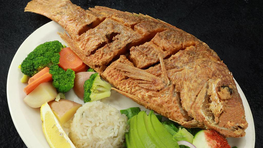 Huachinango · Crispy deep-fried red snapper. Served with steamed vegetables,  rice, slices of avocado, lettuce and tomatoes.