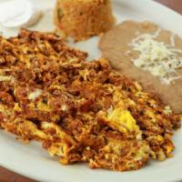 Huevos Con Chorizo · Eggs scrambled with our spicy mexican sausage. Served with mexican rice and refried beans.