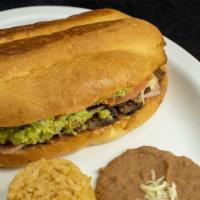 Torta Cubana Con Arroz Y Frijoles · Torta Cubana with Mexican rice and re fried beans.