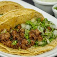 Chorizo Tacos · Served Mexican style with onions, and cilantro.