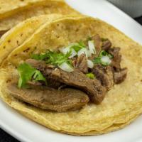 Lengua Tacos · Served Mexican style with onions, and cilantro.