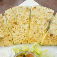 Sincronizada · A large flour tortilla filled with cheese and your choice of meat. Lettuce, tomato, and sour...