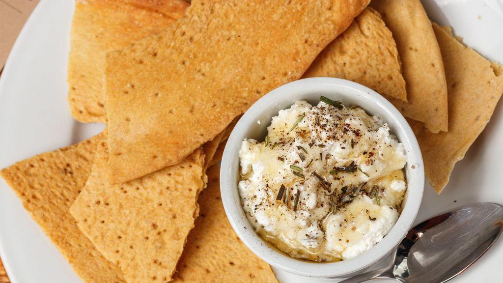 Crackers & Ricotta · House made crackers served with ricotta topped with honey, rosemary, and oregano.