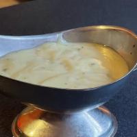 Side Of Creamy Vinaigrette Dressing · Salad that has been tossed with dressing.