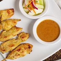 Satay (4) · Skewer-grilled marinated chicken breast served with toast, peanut sauce and cucumber salad.