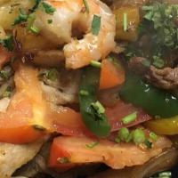 Mar Y Tierra · Grilled steak, shrimp and chicken . sauteed with tomatoes, onions, & bell peppers, served on...