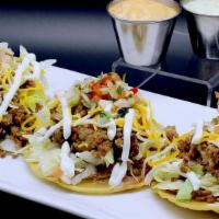 Tostadas · Three fried corn tortilla topped with refried beans, shredded lettuce, seasoned ground beef,...