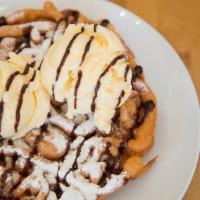 8 Inch Sundae Funnel Cake · Round funnel cake topped with powdered sugar and vanilla ice cream.