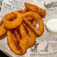 Onion Rings · Thick slices of breaded onions cooked to a golden brown served with ranch sauce.