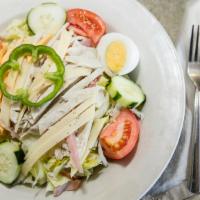 Julienne Salad · Generous strips of ham, turkey, cheese and sliced hard boiled eggs over a freshly mixed gree...