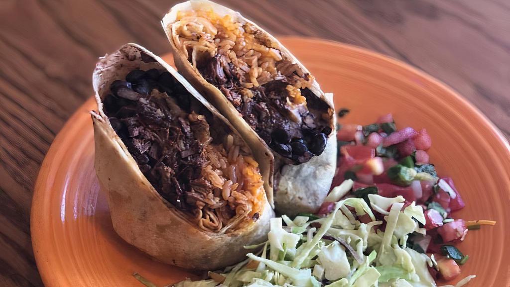 Chipotle Beef Burrito · Cheddar jack, black beans, and rice; served with a side of slaw, pico de gallo, and sour cream