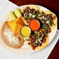 Tijuana Tacos · Gluten free. 3 tacos, steak, chorizo, & pastor. Topped cilantro & onions, c/f tortillas