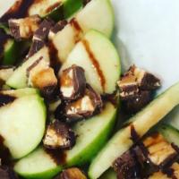 Snickers Apple Nachos · Sliced apples drizzled with chocolate and caramel syrup and topped with chopped snickers