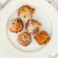 Deep-Fried Oreos (5 Pieces) · five battered Oreos With powdered sugar.