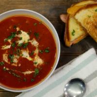 Tomato Bisque Soup · Our hearty tomato broth, cream drizzle, toasted garlic, chili flakes, parsley flakes.