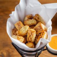 Pretzel Bites · Salted pretzel bites. Served with a tangy cheese sauce on the side.