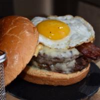 Sunny Side Up Burger · 10oz burger, sunny side up egg, cheddar cheese, Applewood smoked bacon, lettuce, and tomato.