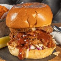 Clark Griswold Pulled Pork Sandwich · Slow roasted BBQ pulled pork served on a brioche bun with onion strings, jalapeños, Gouda ch...