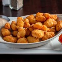 Hand Battered Cheese Curds · Wisconsin white cheddar curds, served with marinara sauce and chipotle ranch.