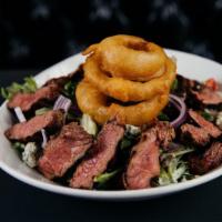 Steakhouse Salad · Ribeye steak strips, mixed greens, garlic roasted mushrooms, red onions, bleu cheese crumble...