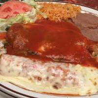 Combinacion Poblana · One poblano pepper stuffed with cheese, one chicken enchilada, two pieces of nachos, rice an...