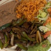 Fajitas De Bistec · Steak fajitas. Strips of steak, green peppers and onions. Served with rice, refried beans, g...