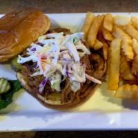 Bbq Pulled Pork · House roasted pulled pork grilled in BBQ sauce and topped with coleslaw.