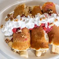 M. Banana Split Breakfast Favorite · Blueberry pancakes wrapped around halved bananas and topped with strawberries, whip cream, a...