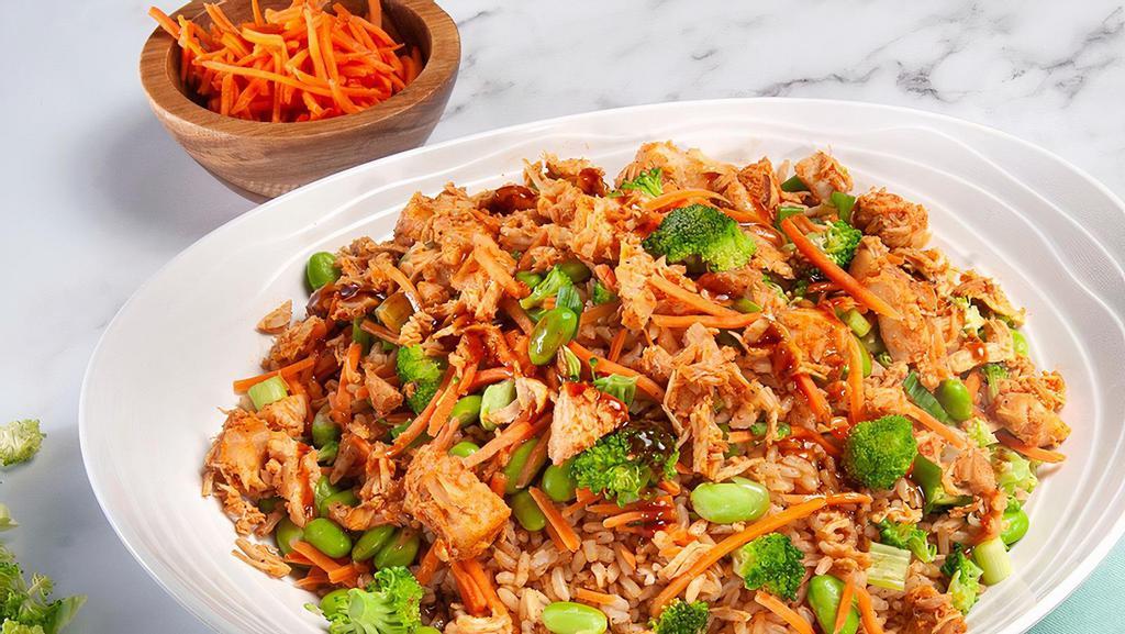 Spicy Teriyaki Chicken Bowl · Made with cilantro brown rice, napa cabbage, honey chipotle chicken breast, steamed shredded carrots, green onions, broccoli florets, and edamame. Served with sesame ginger and spicy teriyaki glaze dressing.