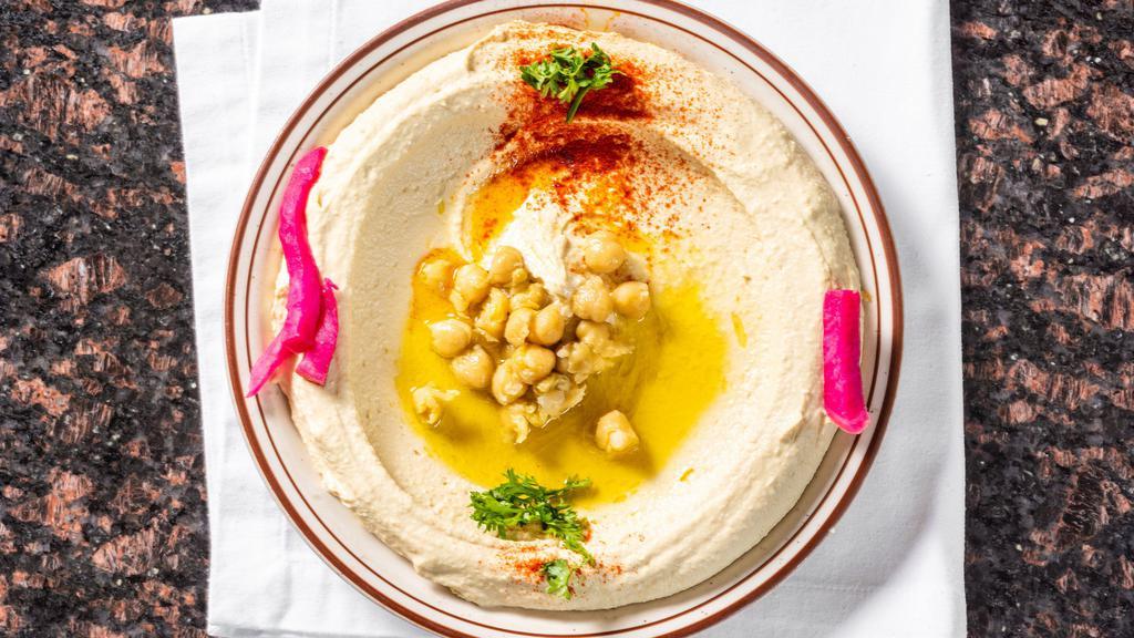 Hummus · Pureed chickpeas, creamy tahini sauce, garlic, served with warm pita bread.