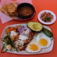 Huevos Rancheros · 2 Sunny side up eggs on top of two tortillas and covered in sauce. 2 huevos estrellados enci...