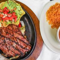 Carne Asada · In a skillet, bell peppers, grilled onions, Monterrey cheese. Served with rice, charros bean...